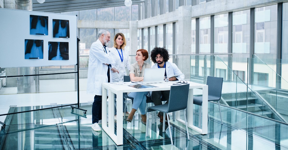 group of doctors standing in an office building.