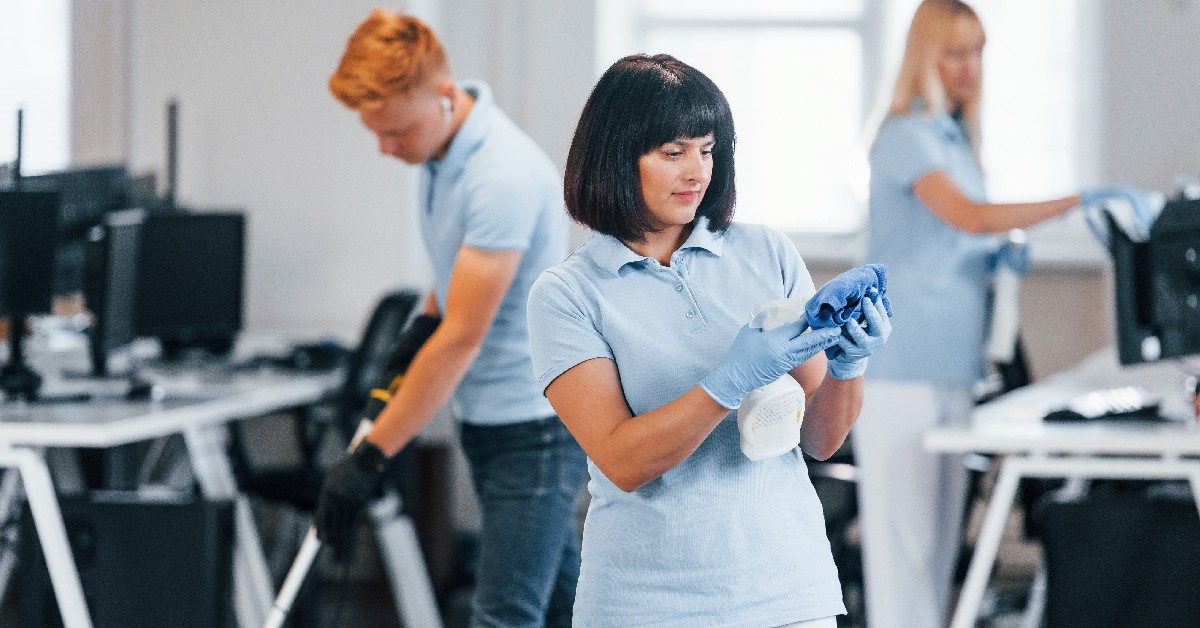Janitorial team performing cleaning in an office setting