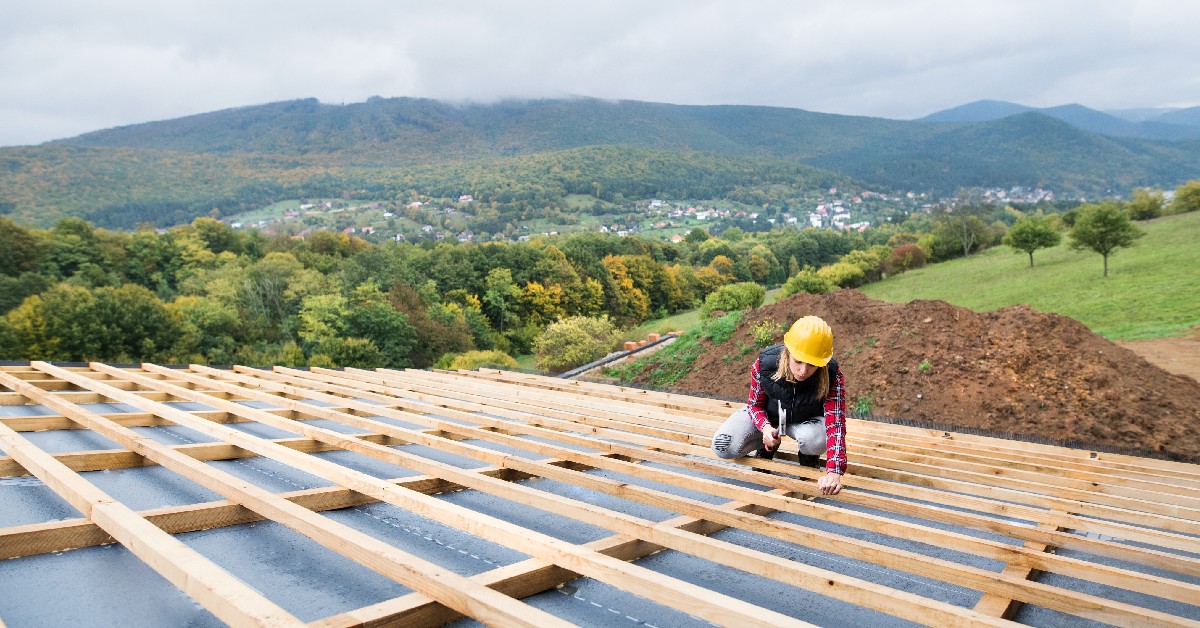 Female roofing installer working on a roof